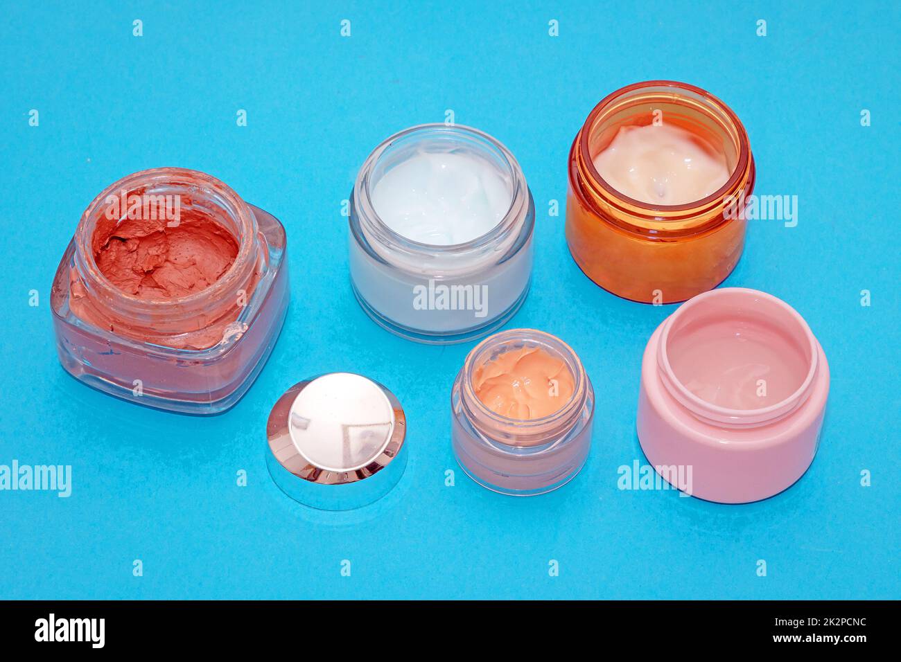 Open glass jars with beauty creams Stock Photo Alamy