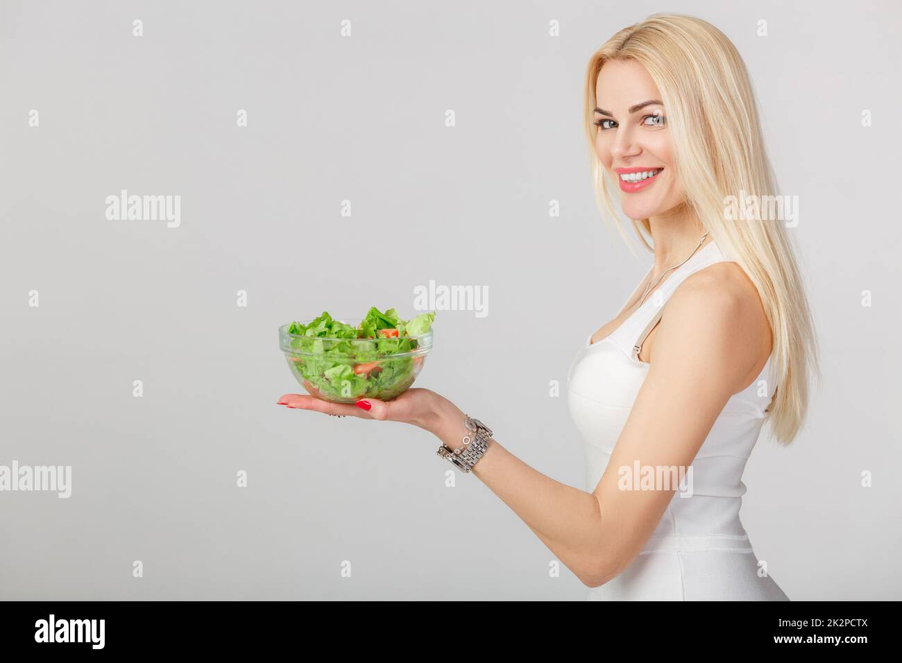 woman in white dress with fresh salad Stock Photo Alamy