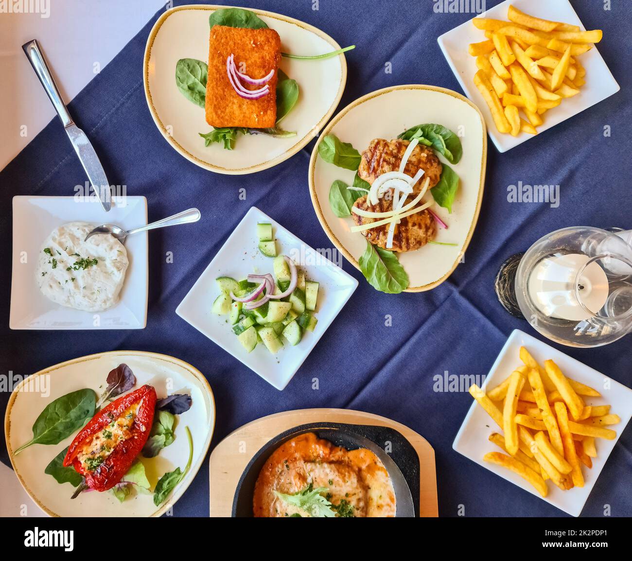 Many bowls with food on a table - Greek buffet in a restaurant. Stock Photo