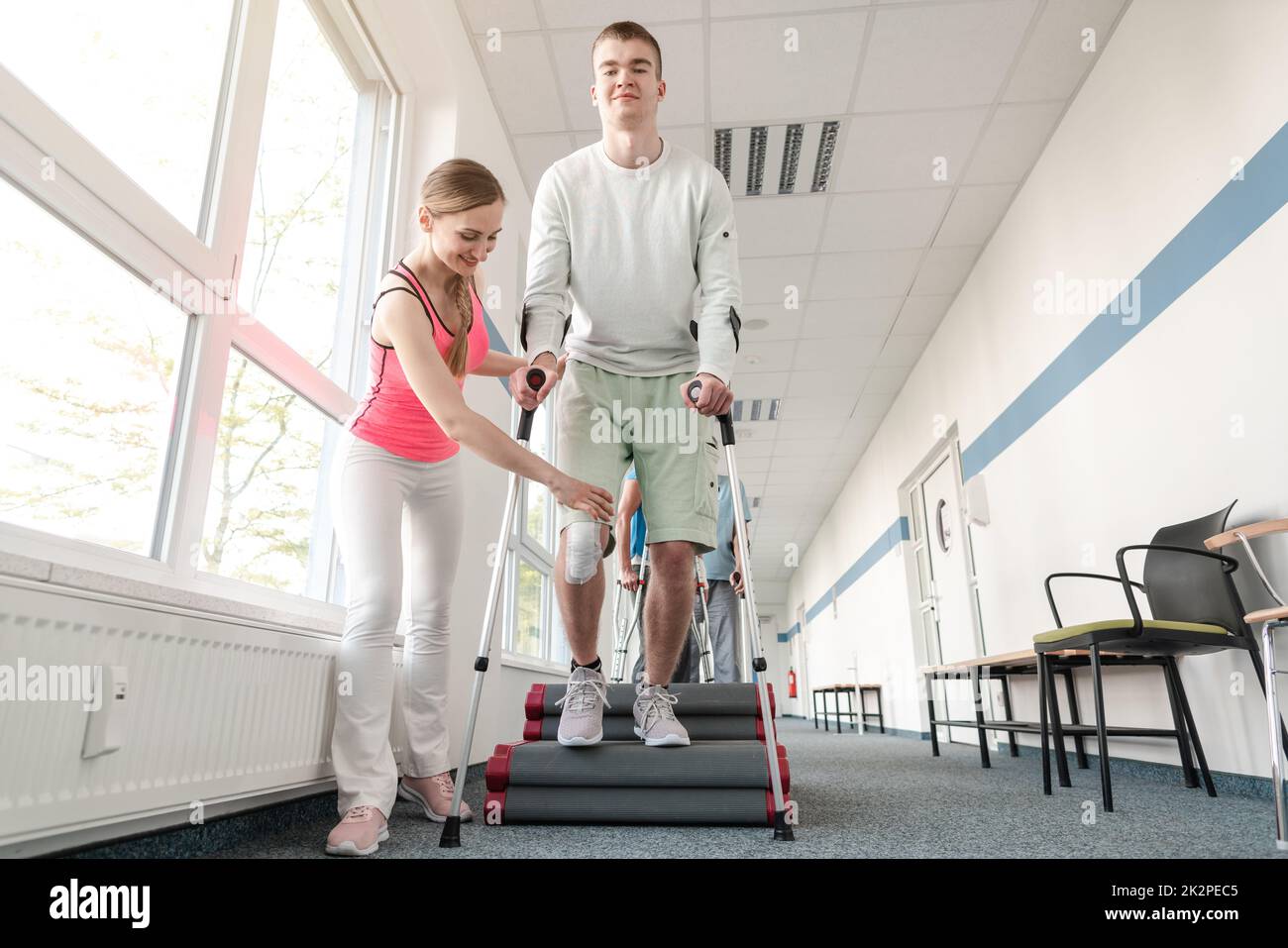 People in rehabilitation learning how to walk with crutches Stock Photo