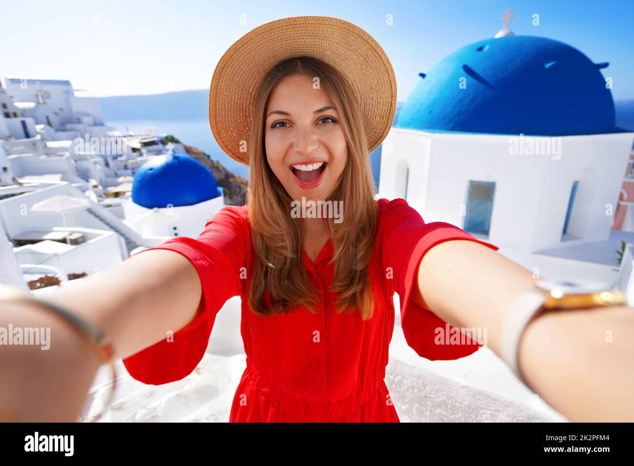 Traveler girl taking a selfie on her vacation in Santorini, Greece Stock Photo