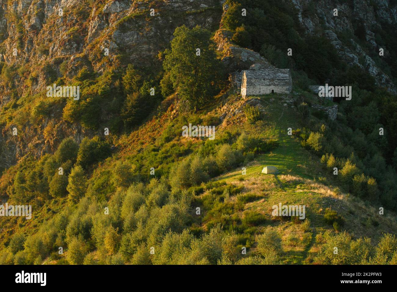 Green camping tent on top of mountain with amazing sunrise light in Val ...