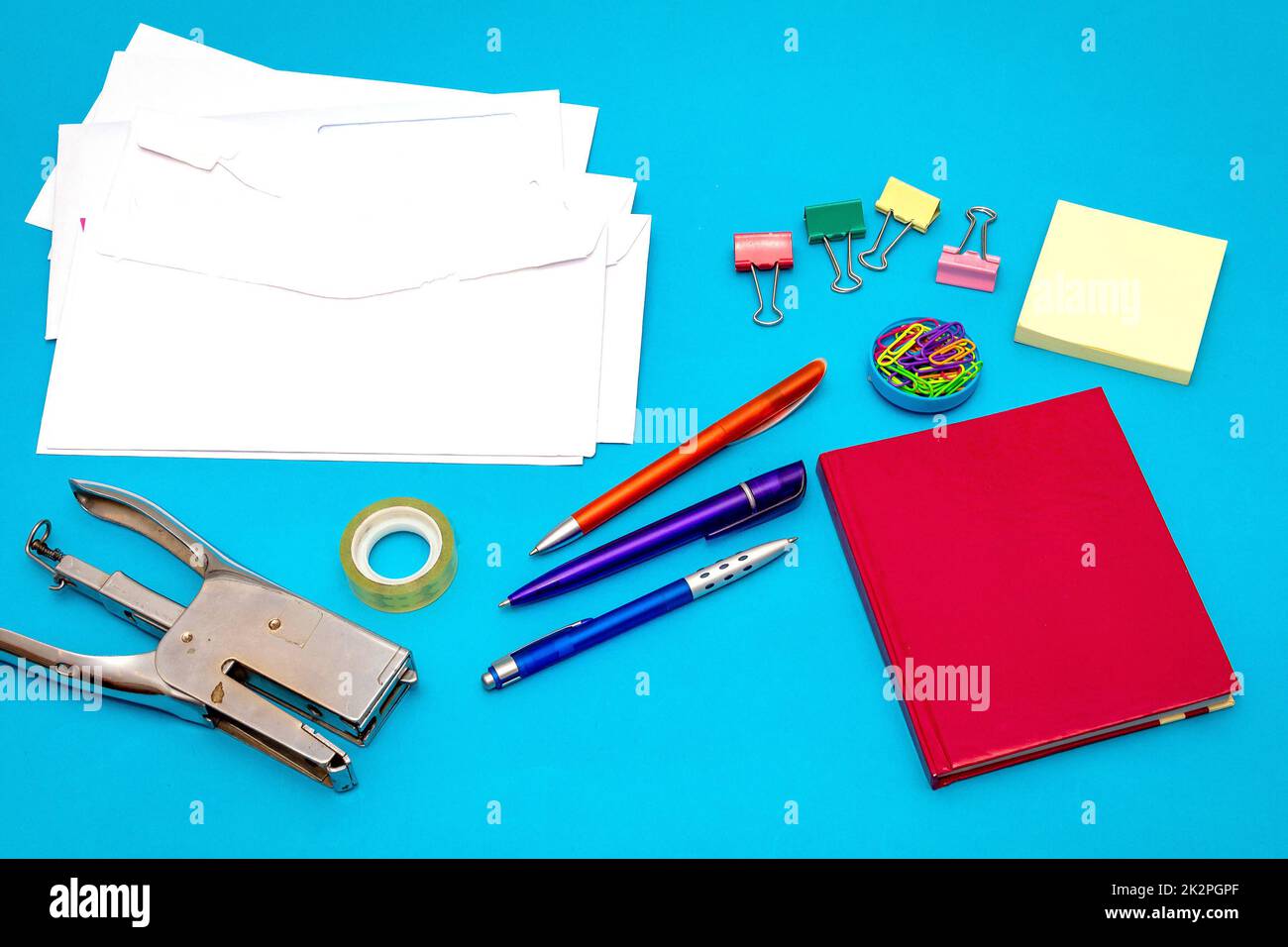 Office stationery objects on blue background Stock Photo Alamy