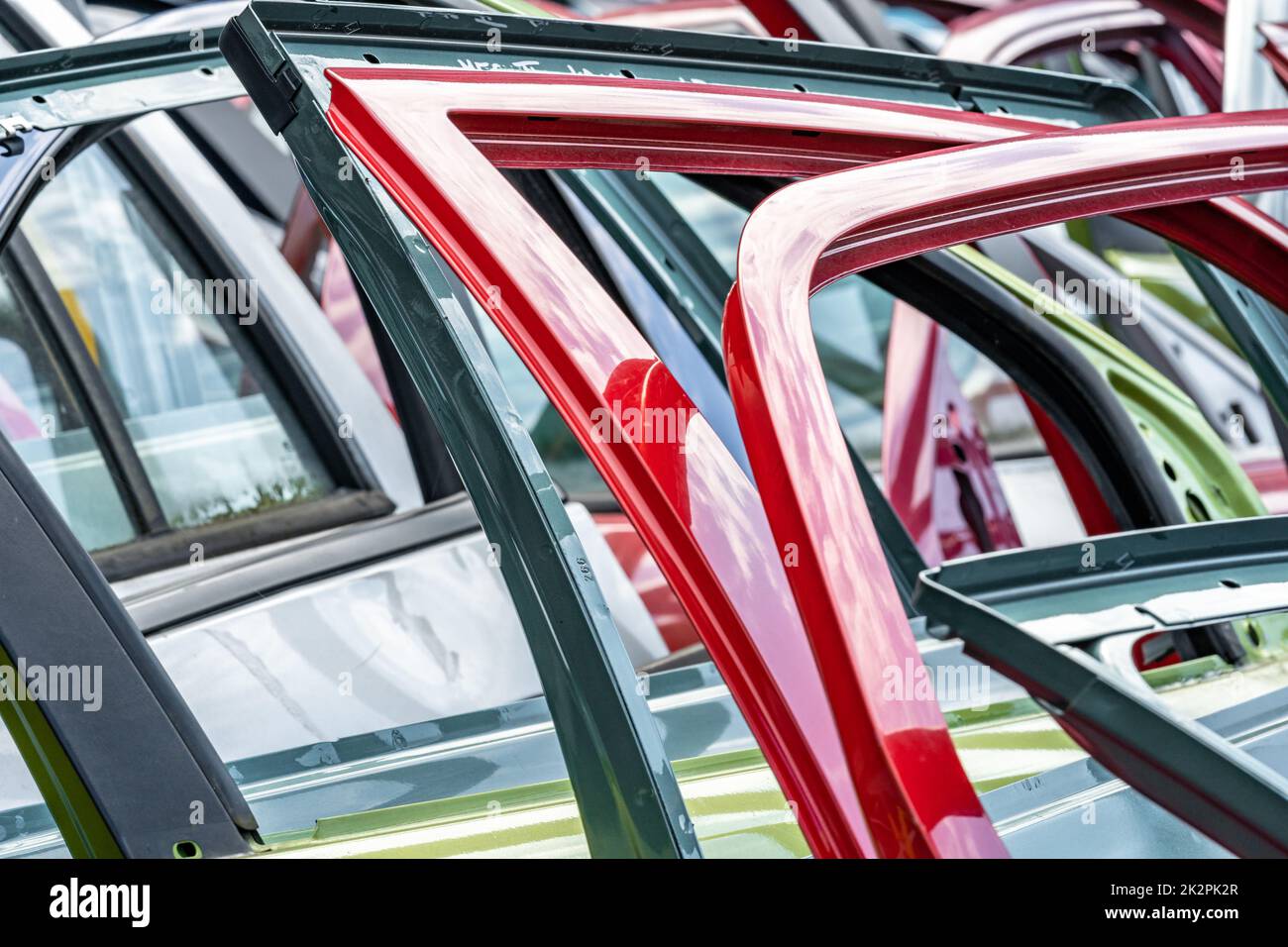 different colored car doors at a car junkyard Stock Photo Alamy