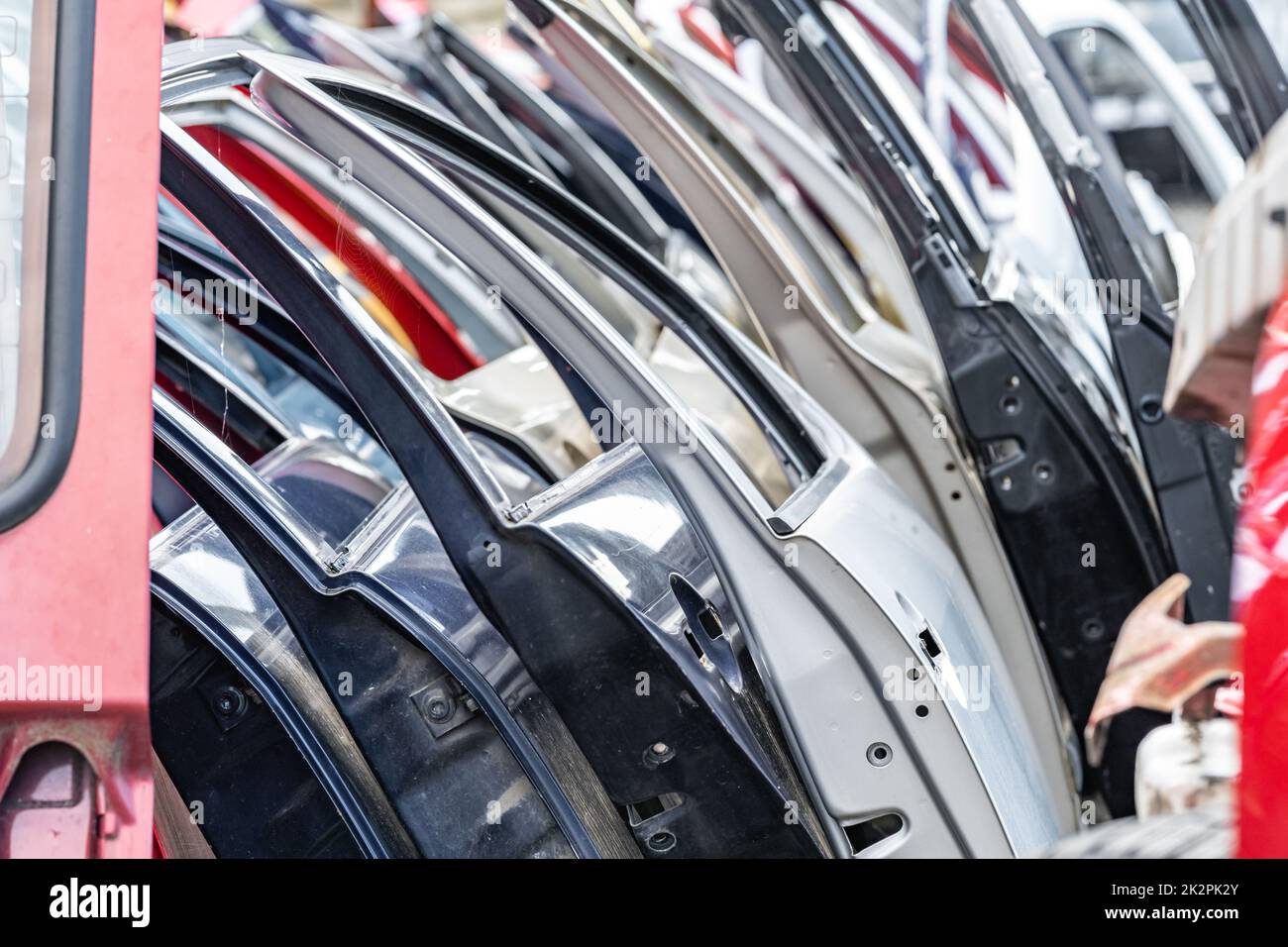 different colored car doors at a car junkyard Stock Photo Alamy