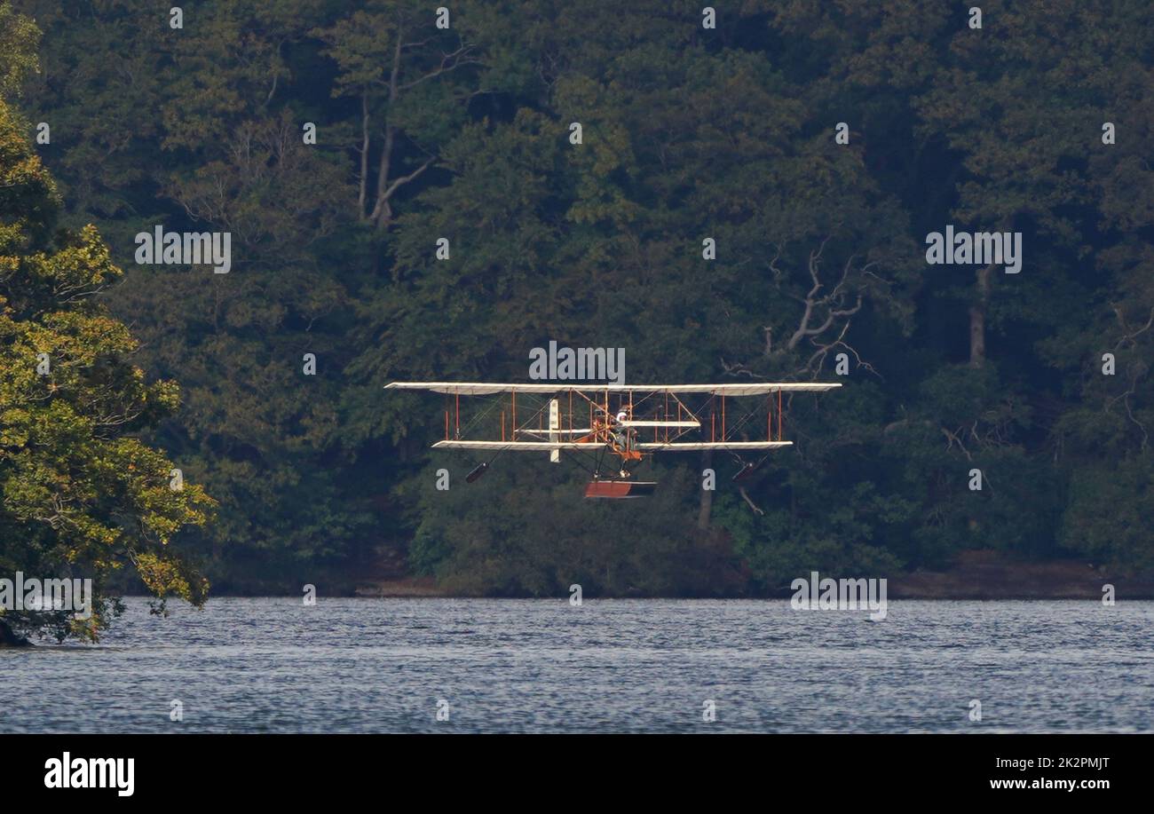 A replica of Waterbird, the UK's first successful seaplane and the only one its kind in the world, during its first public flight on Lake Windermere in Cumbria. The event marks the climax of a 13-year project to create an exact copy of the Waterbird and apart from a modern engine, it faithfully recreates the detail of the original from 1911 seaplane. Picture date: Friday September 23, 2022. The replica has been constructed from wood, bamboo and wires, the same materials used to construct the original seaplane. The 35ft long aircraft, has a wingspan of 40ft and weighs just 1000lb. It is powered Stock Photo