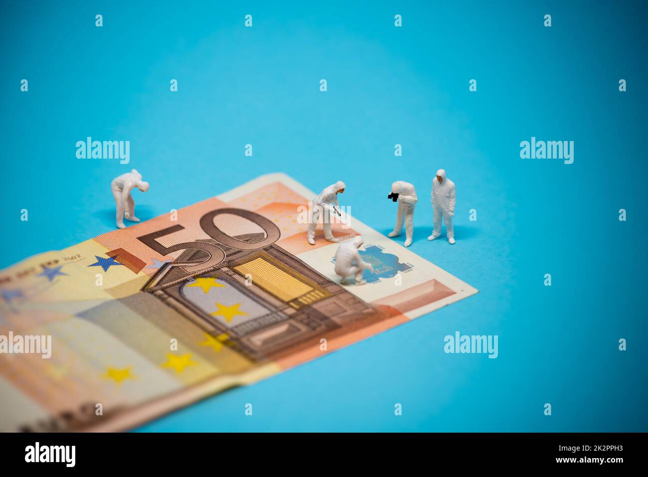 Specialists inspecting 50 euro banknote. Fraud concept Stock Photo