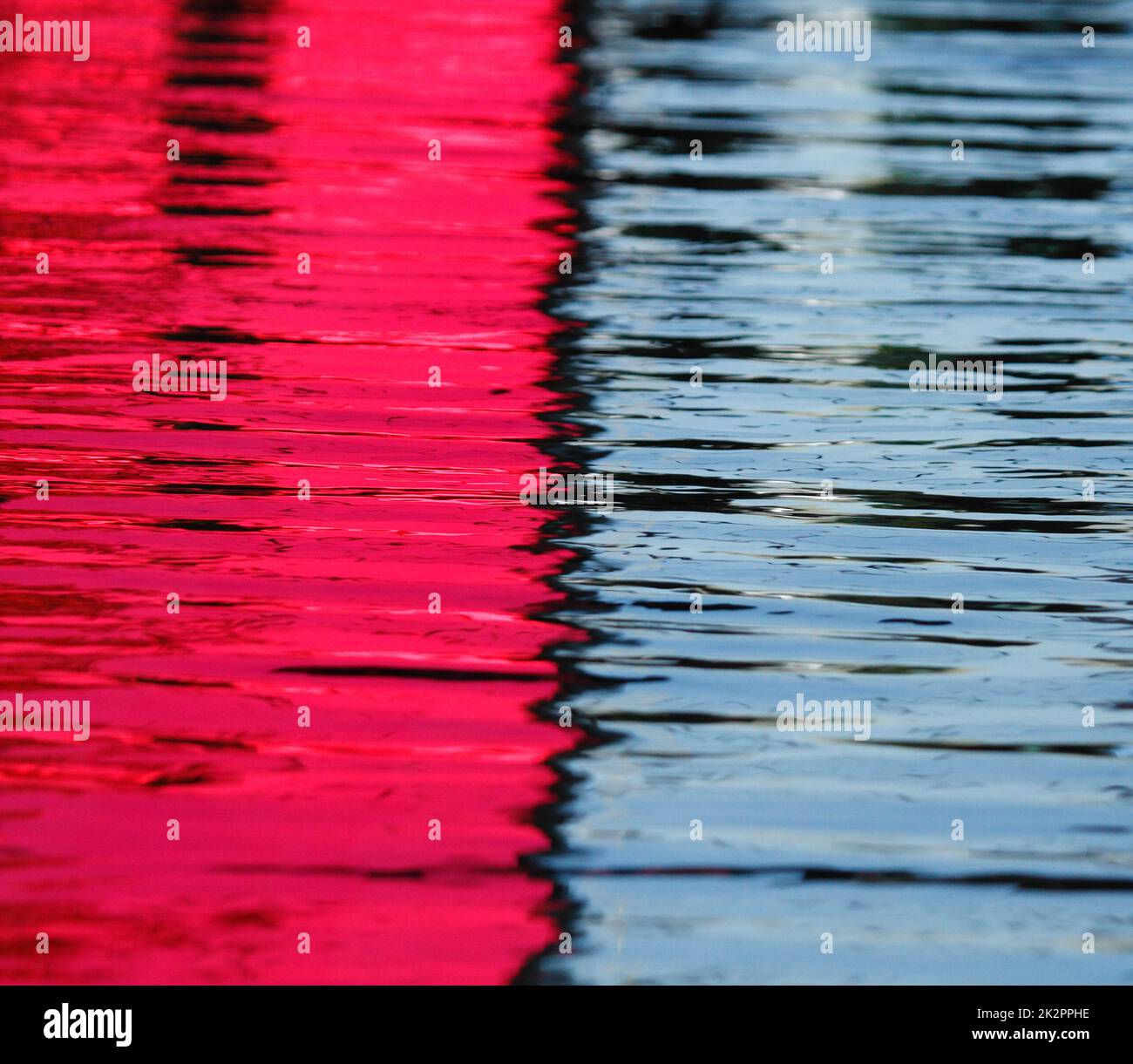 Shining blue and pink water in pool, surface with ripples on reflecting