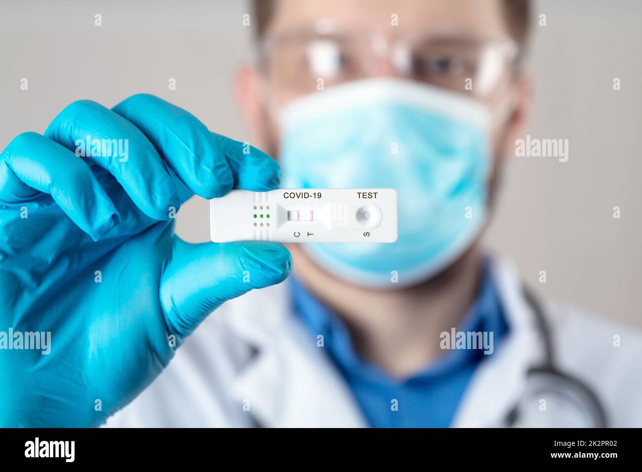 Positive test result by using rapid test device for COVID-19. Stock Photo