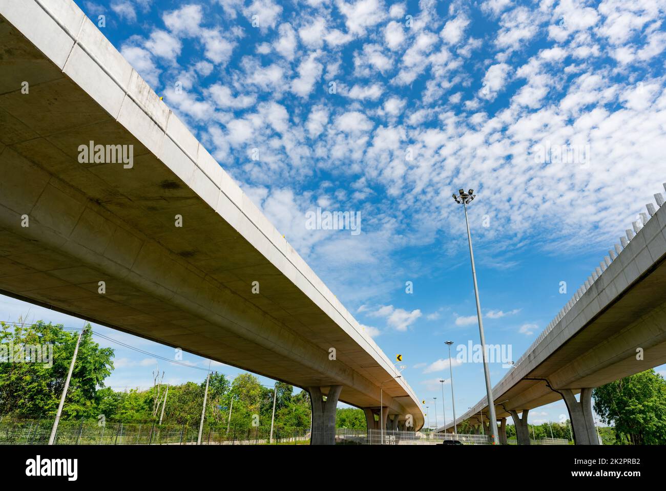 Bottom view of elevated concrete highway. Overpass concrete road. Strong structure of cement bridge. Concrete bridge engineering construction. Bridge architecture. Infrastructure budget policy concept Stock Photo