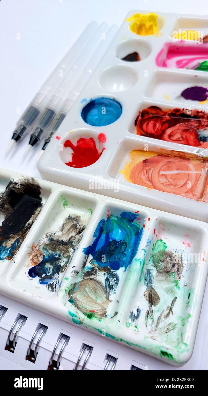 Flat lay sketchbook, watercolor brushes and color palette Stock Photo