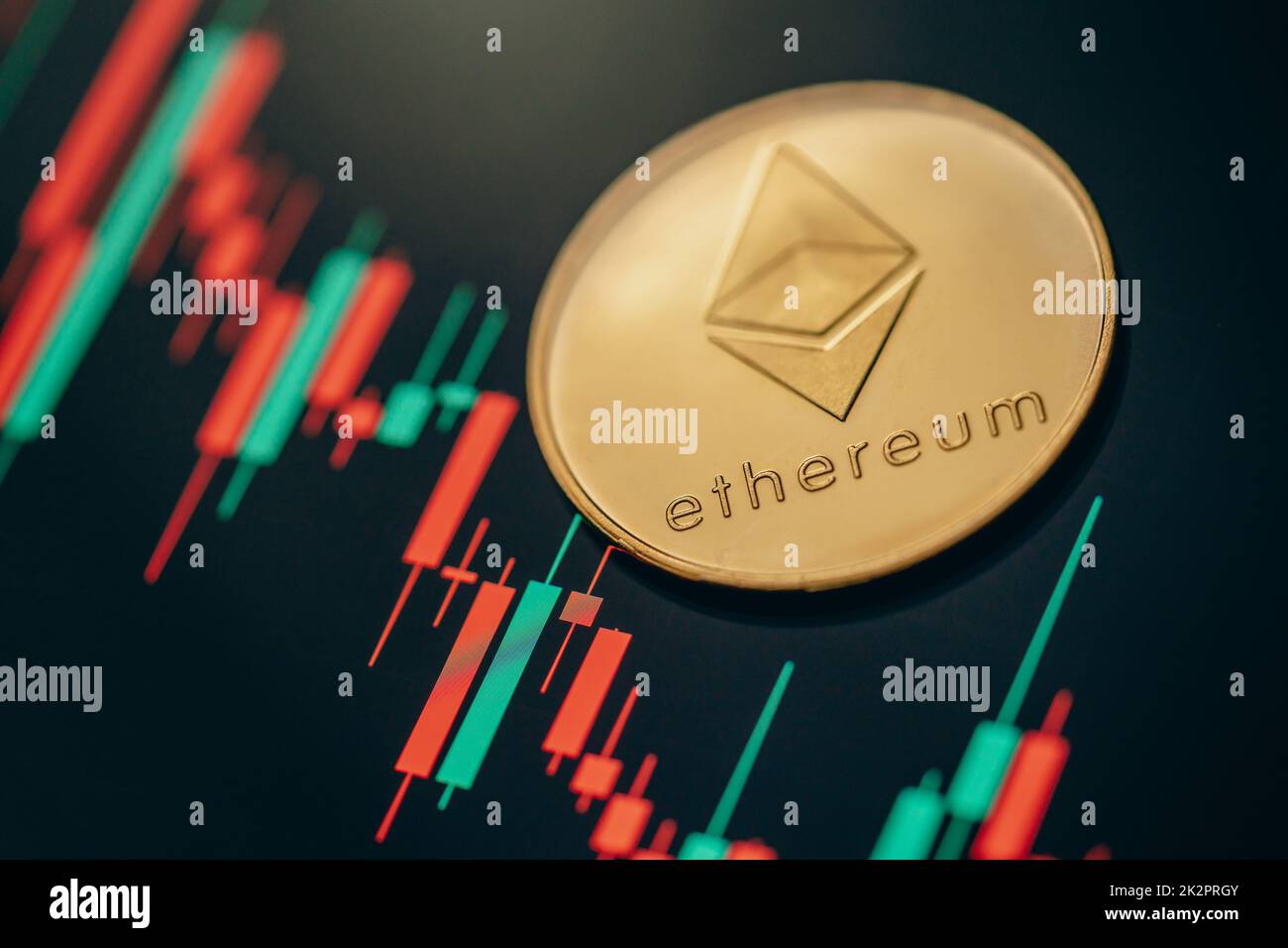 Gold Ethereum cryptocurrency coin with candle stick graph chart and digital background. Stock Photo