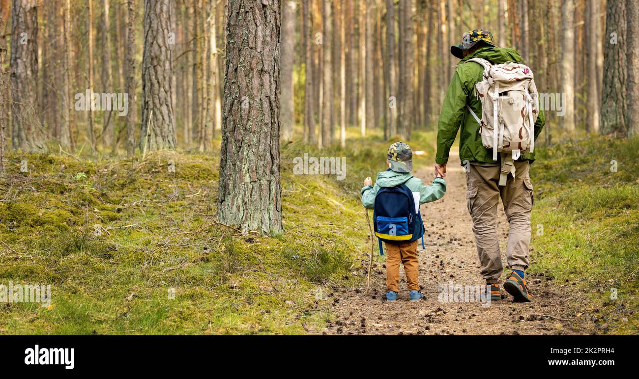 father and son on a adventure hike in forest. bonding activities, nature explore Stock Photo