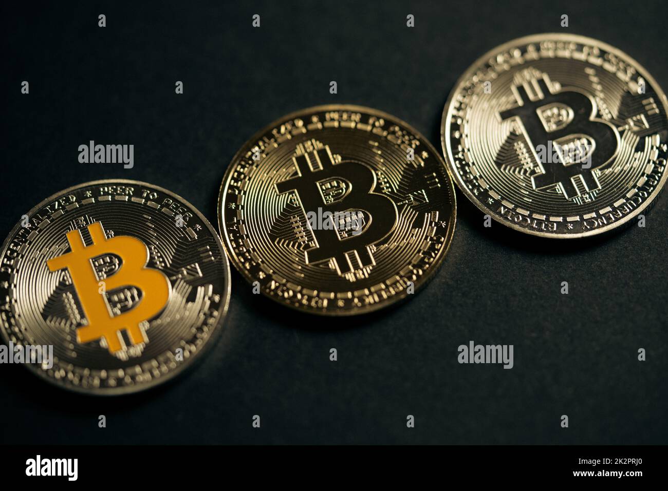 Close up shot of three aligned golden and silver bitcoin digital cryptocurrency. Stock Photo