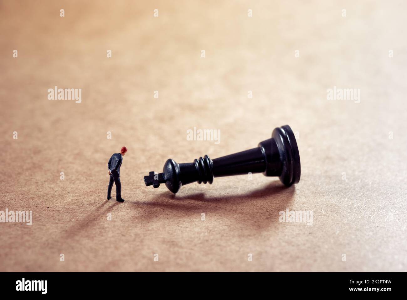Pensive businessman looking at chess figure Stock Photo