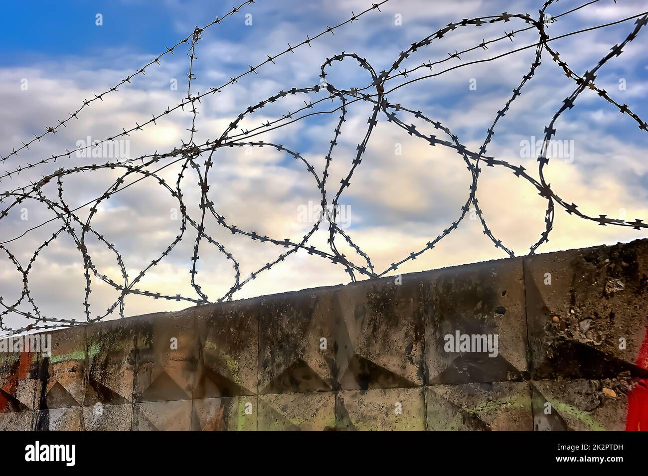 Barbed wire on a blue sky background Stock Photo - Alamy