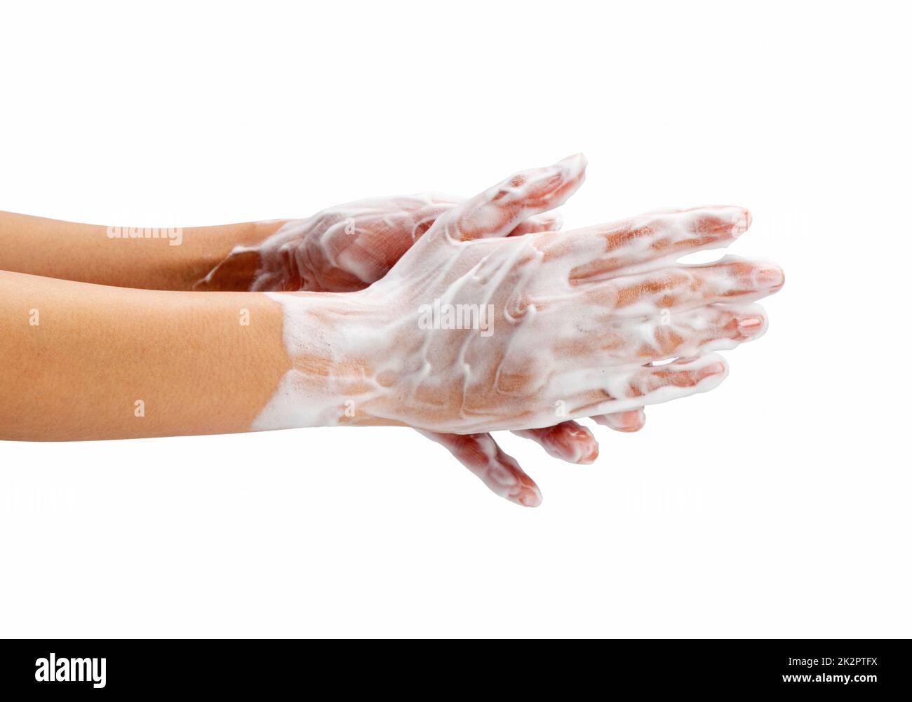 Female hand washing hands with soap lather on white background. Stock Photo