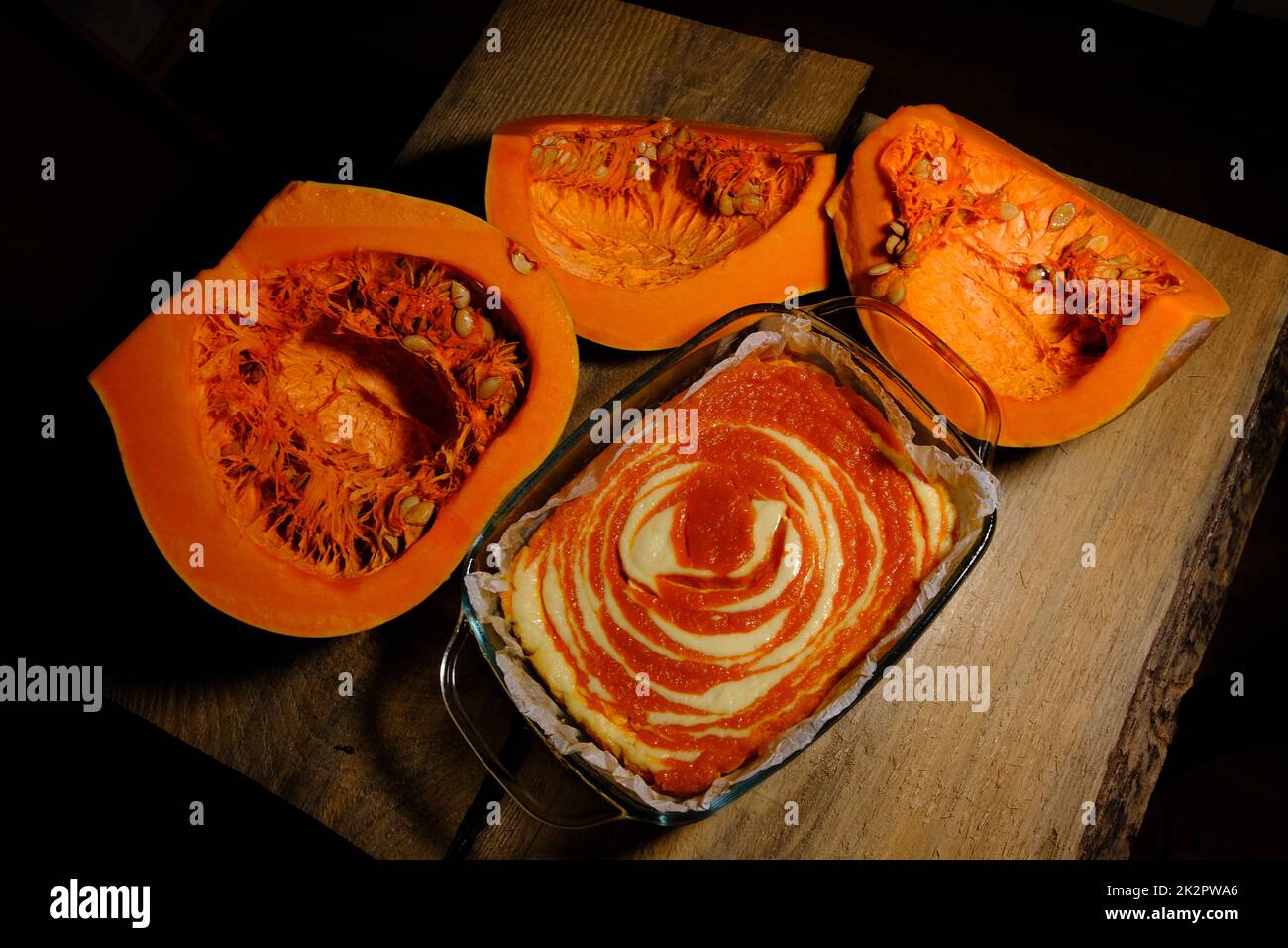 Homemade pumpkin pie cheesecake with piece of pumpkin. Orange dessert. vertical image. top view. wooden background Stock Photo