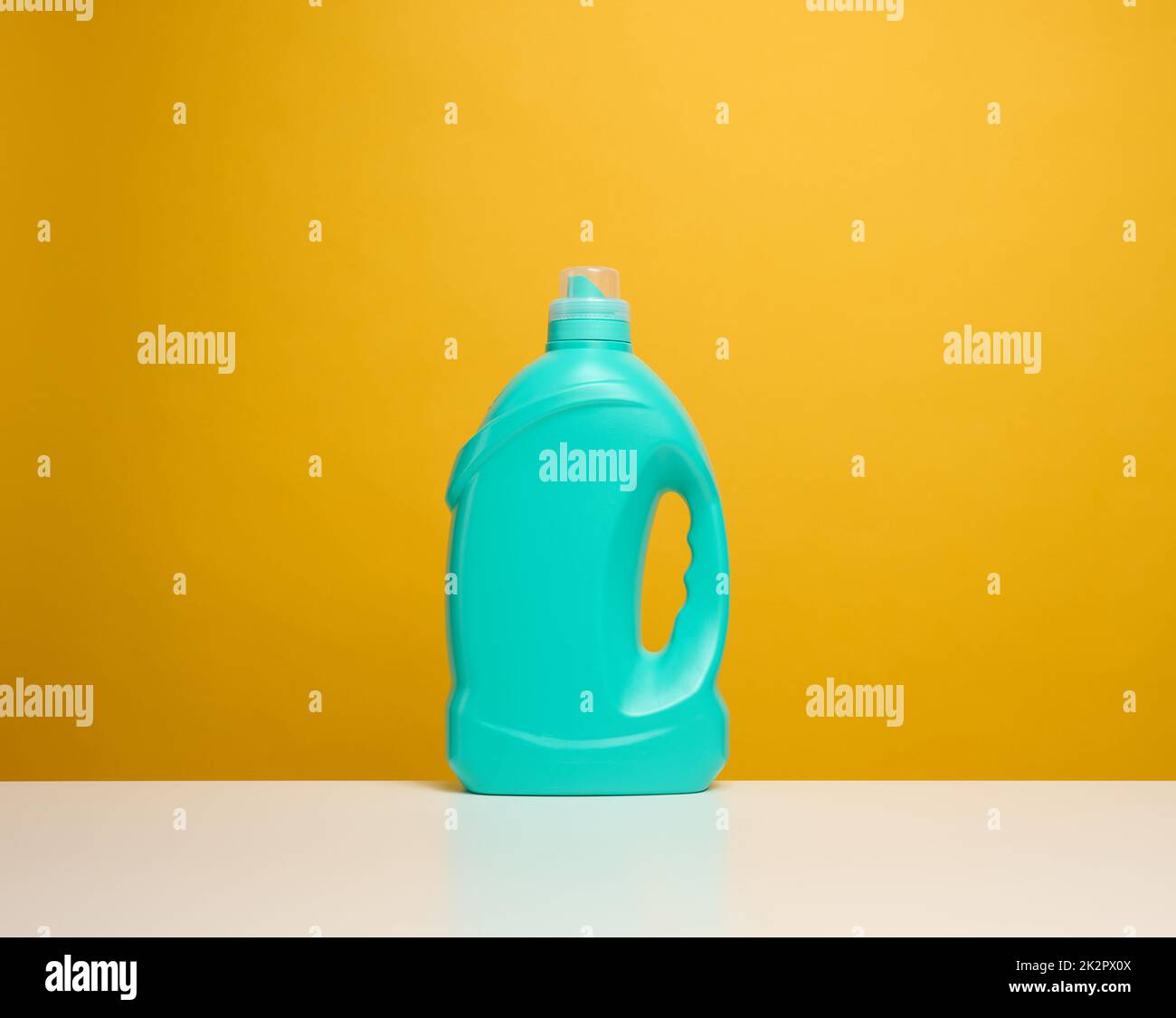 plastic blue bottle with liquid detergent stand on a white table Stock Photo