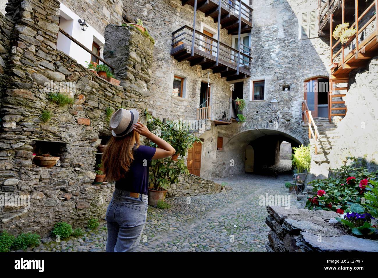 Beautiful young woman visiting Sondrio picturesque cozy alpine town in Valtellina, Lombardy, Italy Stock Photo