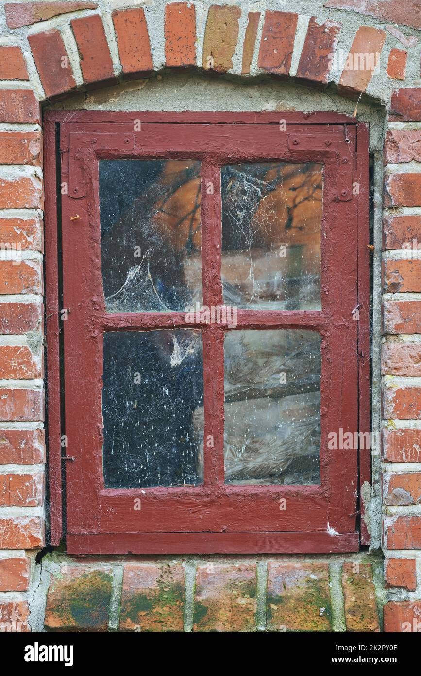 Your view to the world. A close-up image of a rustic window frame on a brick house. Stock Photo