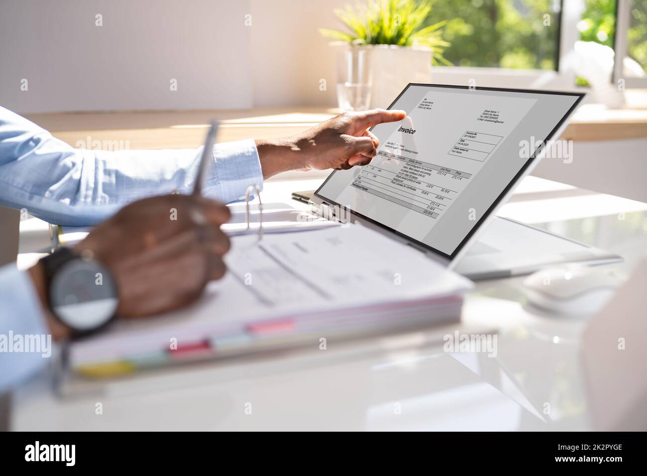 Accountant calculating tax at desk Stock Photo Alamy