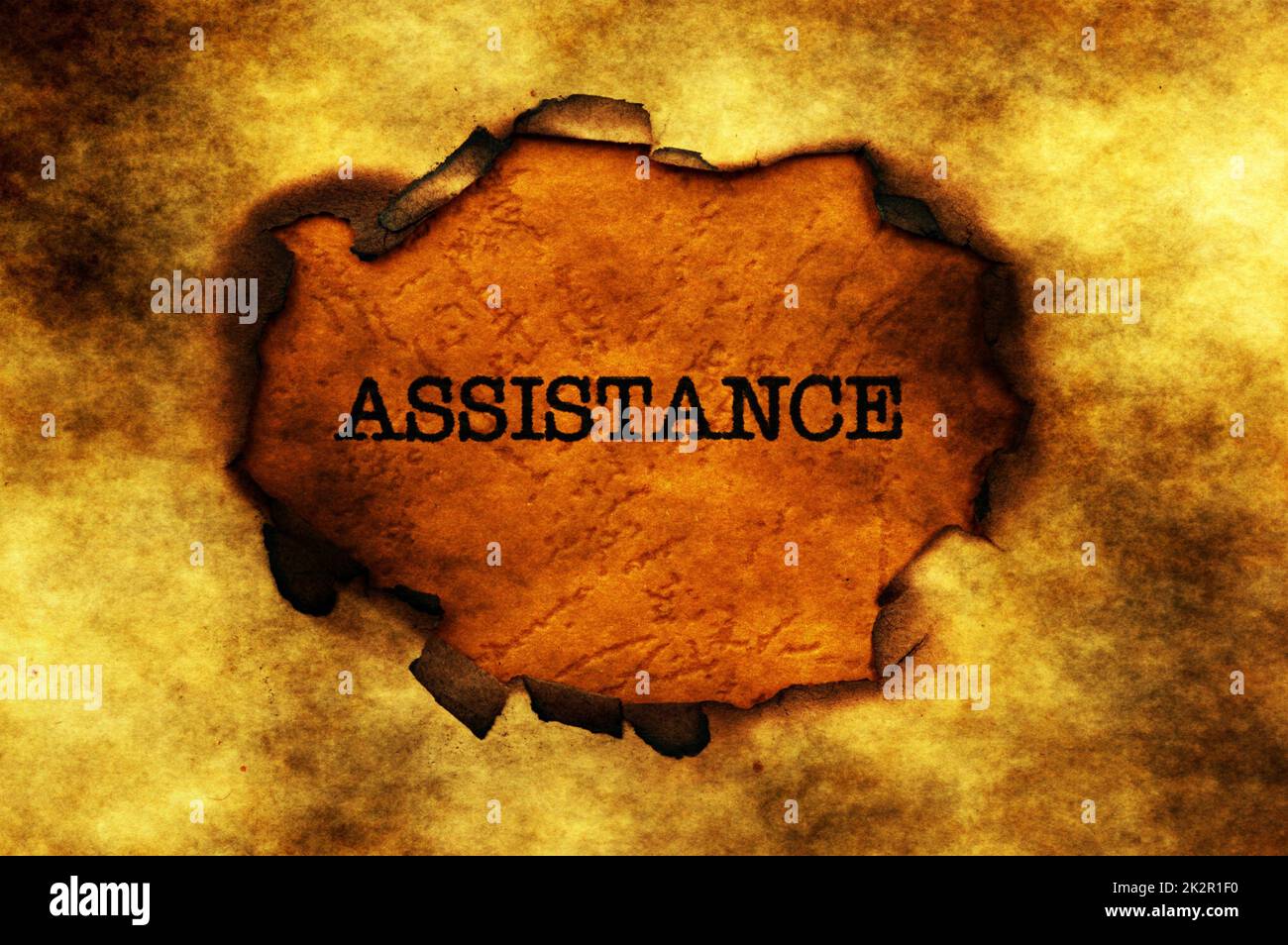 Assistance  text on paper hole Stock Photo