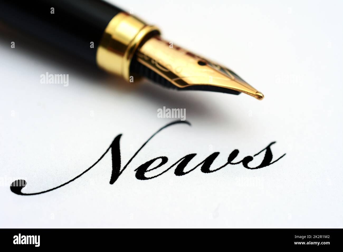 Fountain pen on news text Stock Photo