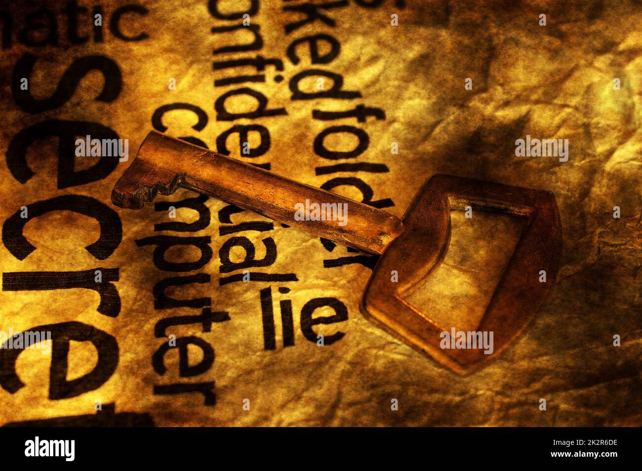 Golden key on lie text Stock Photo - Alamy