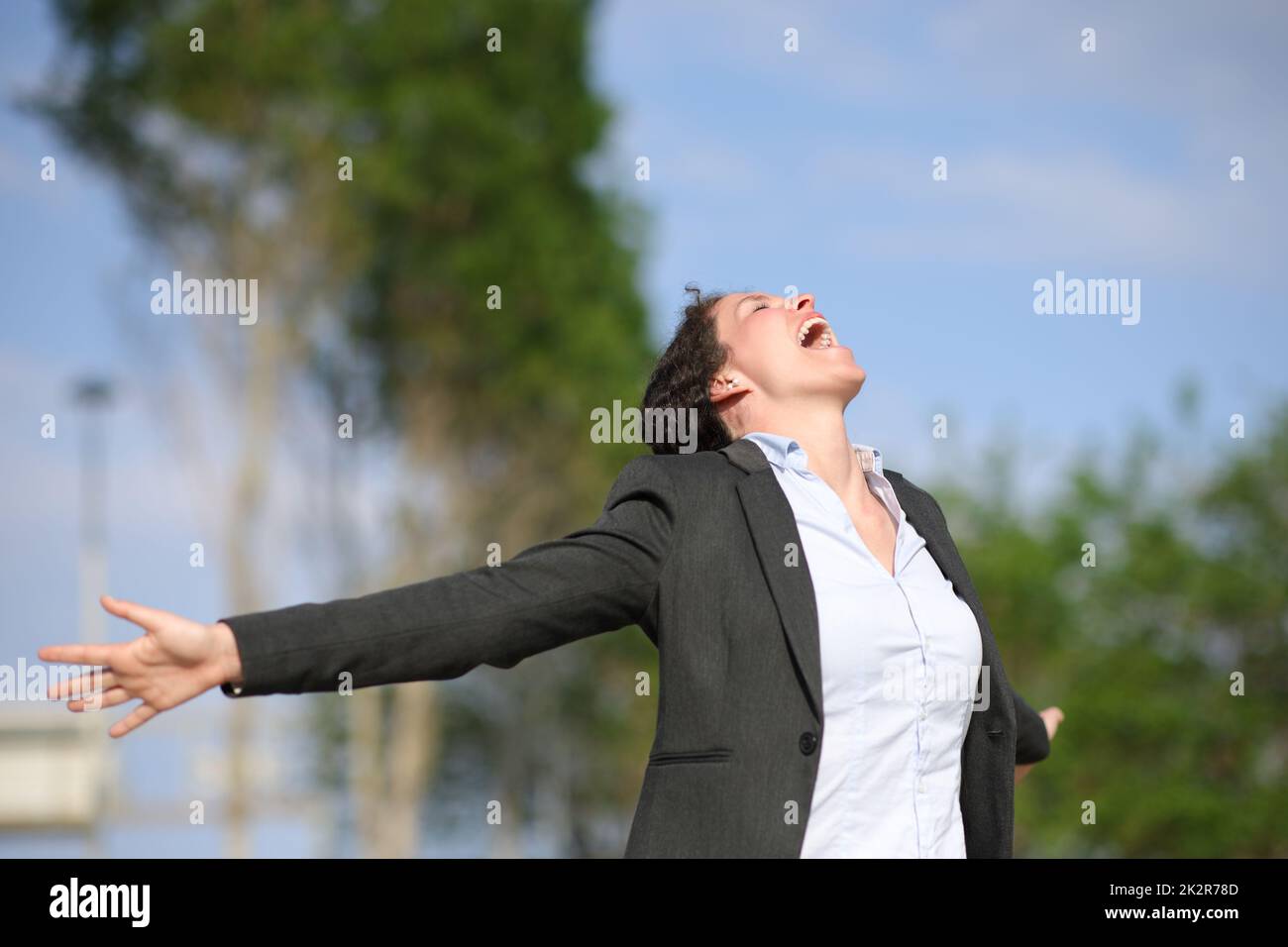 Excited executive screaming and outstretching arms Stock Photo - Alamy