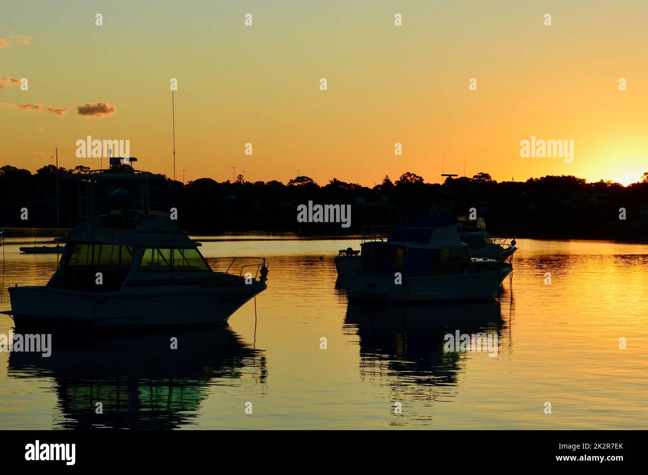 Boats on the harbor at sunset Stock Photo