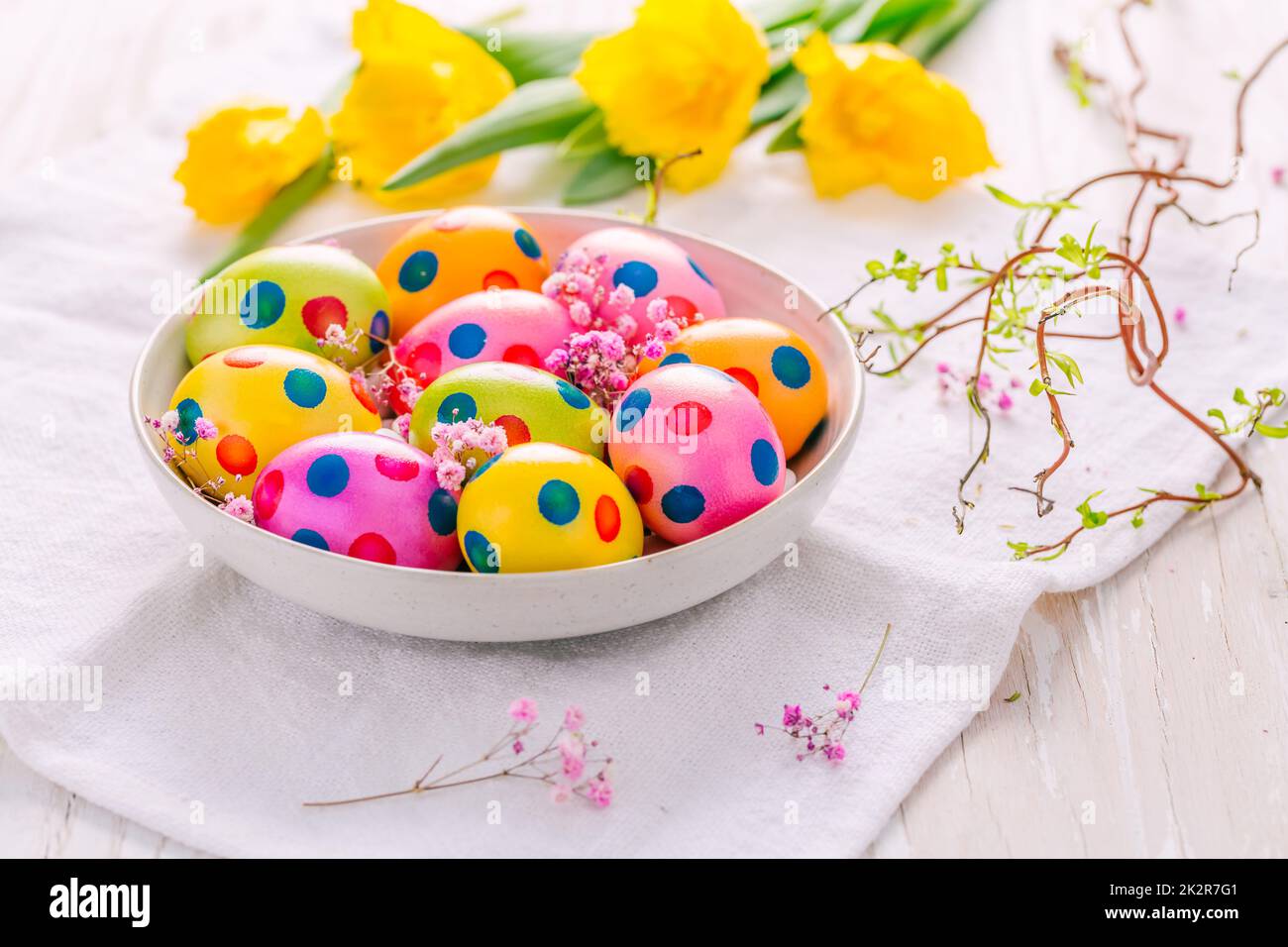 Easter eggs and tulips on grey background Stock Photo