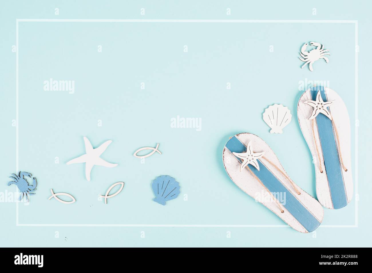 Blue colored summer and holiday background, flip flops, sea stars and crabs with copy space, travel and tourism concept Stock Photo
