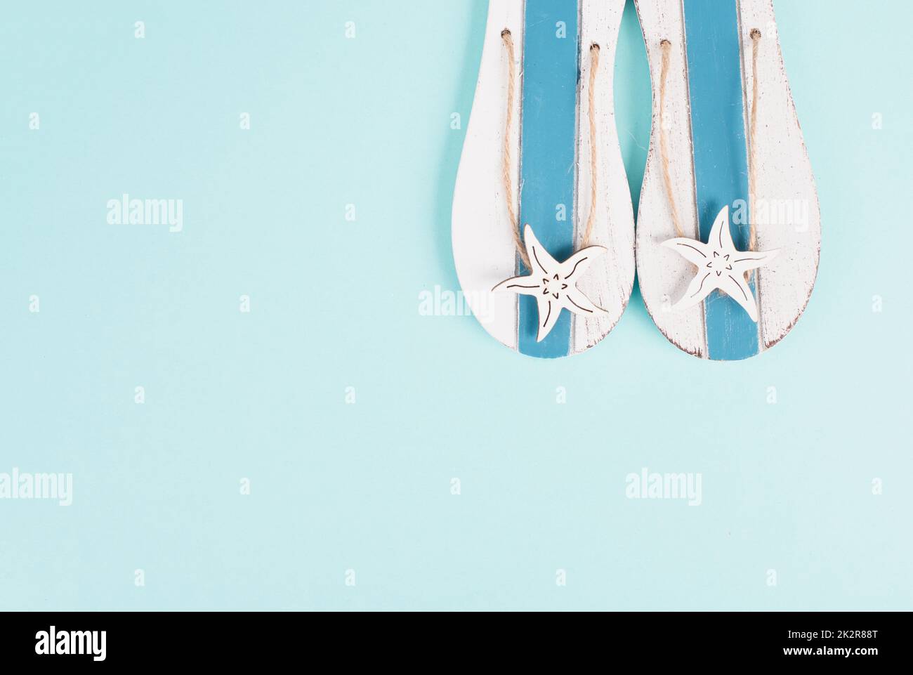 Blue colored summer and vacation background, slippers with sea stars, copy space for text, holiday and tourism concept Stock Photo