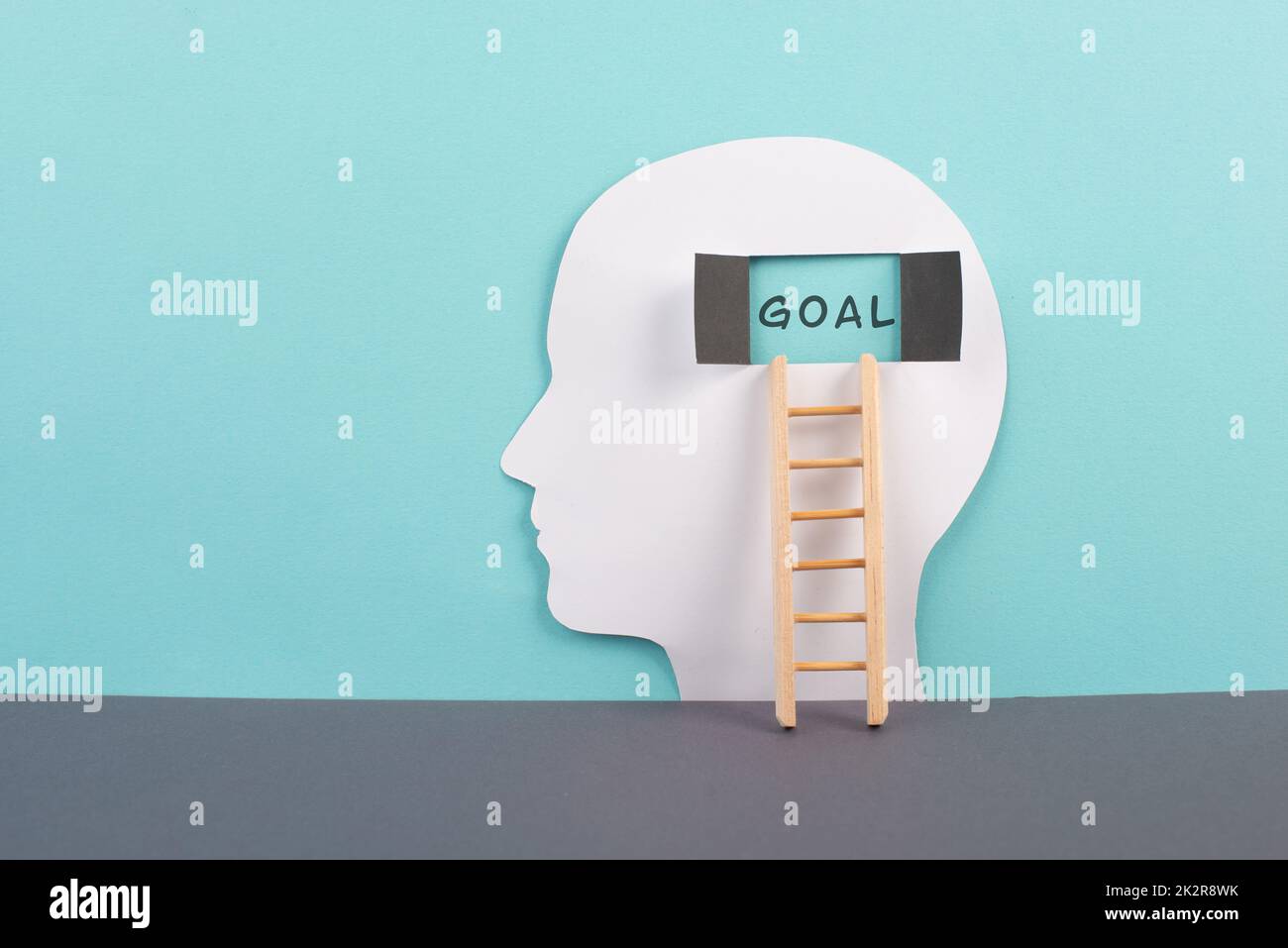 Silhouette of a man, window to the brain with the word goal, ladder of success, open minded, brainstorming for business ideas Stock Photo