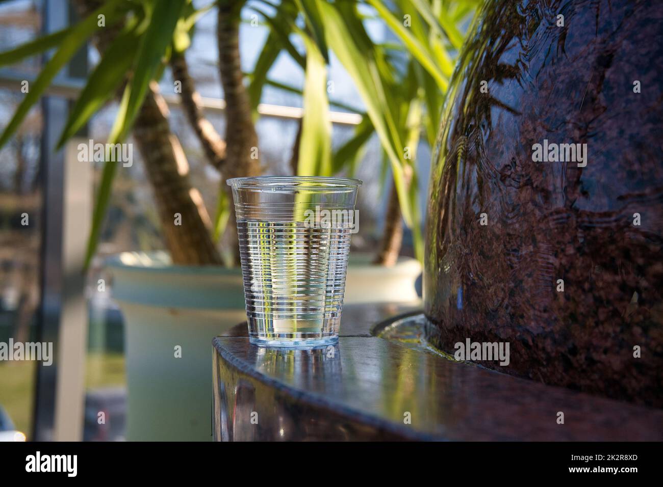 Glass of clean fresh water on a marble fountain Stock Photo
