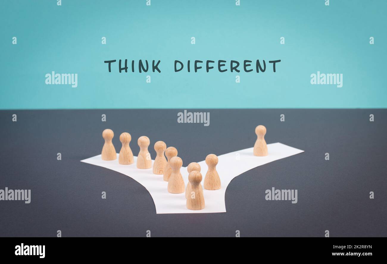 Think different stands on the blue background, one nonconformist is standing out from the crowd, creative and visionary concept, mass follows the group Stock Photo