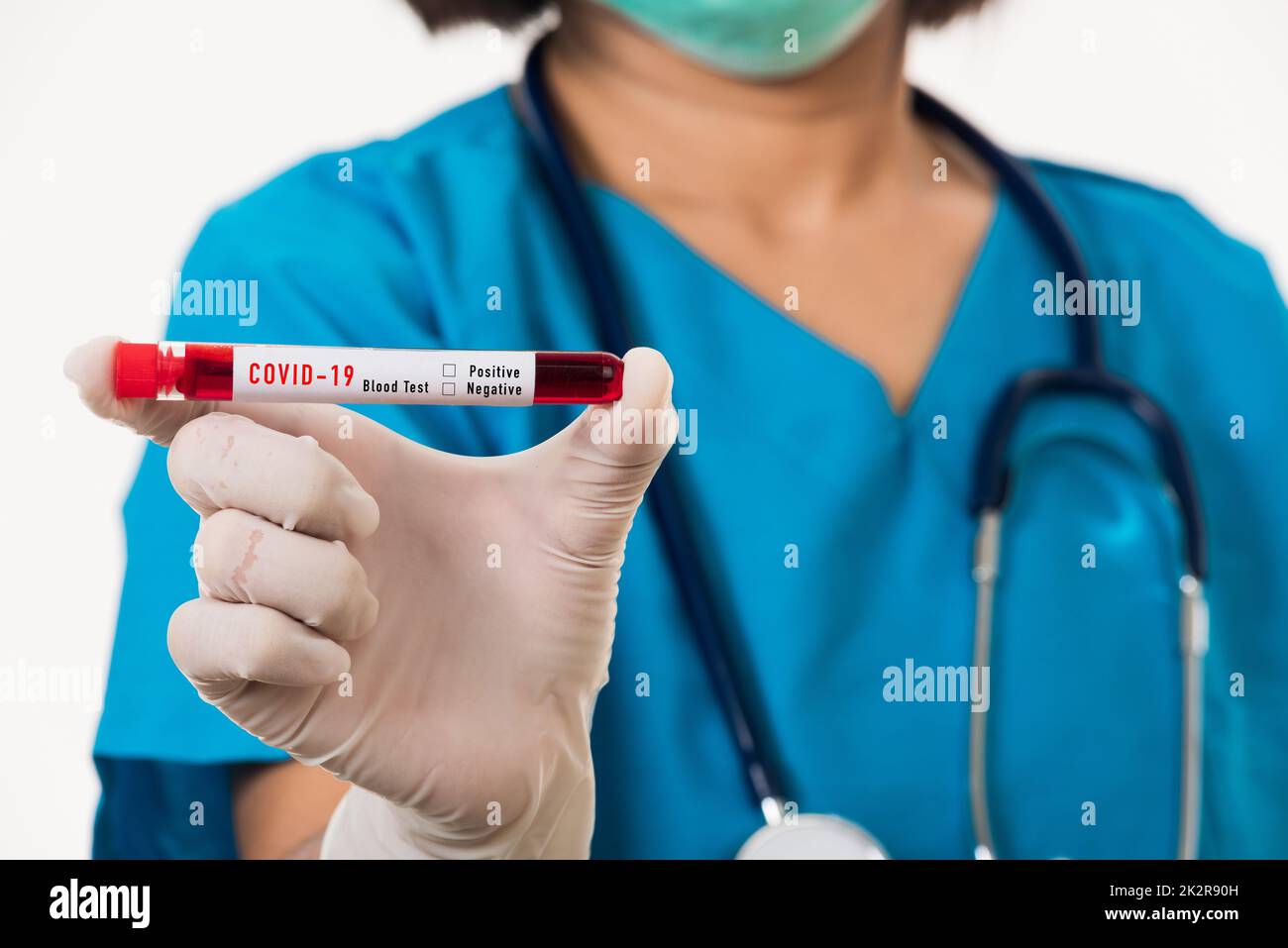 Nurse in blue uniform wear a mask holding test tube sample Coronavirus
