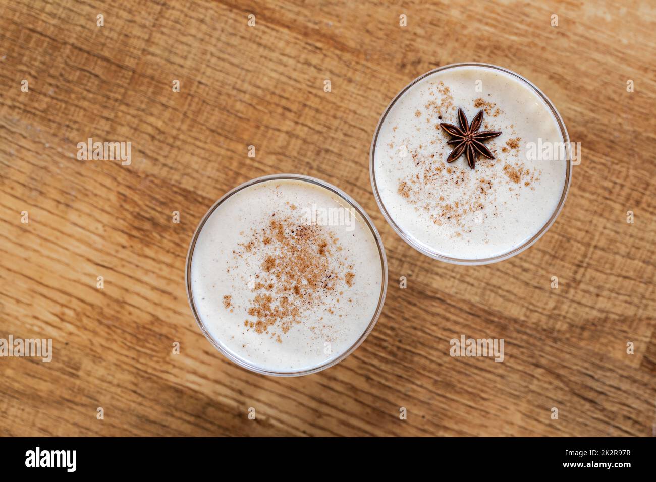 Homemade eggnog with grated nutmeg and cinnamon. Traditional Christmas