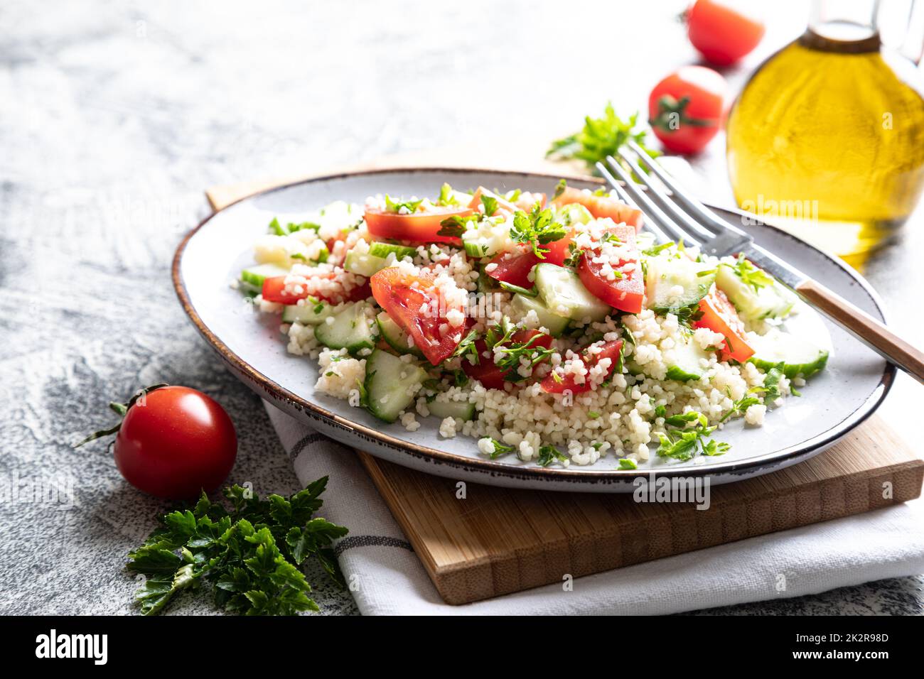 Traditional oriental salad Tabouleh. Tabule cous cous salad with vegetables. Tabbouleh with bulgur Stock Photo