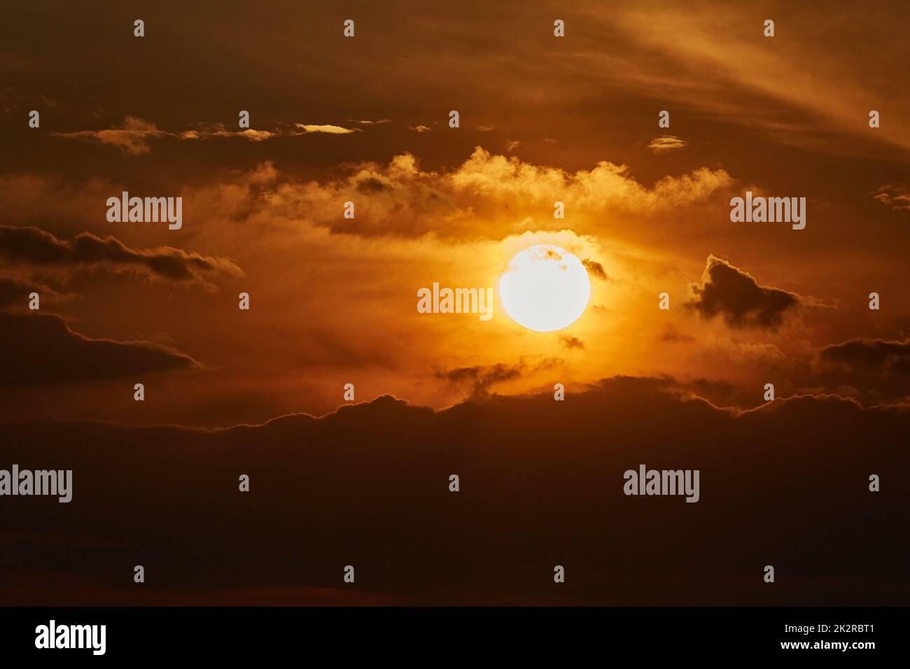 Sunset through cloudy red sky Stock Photo