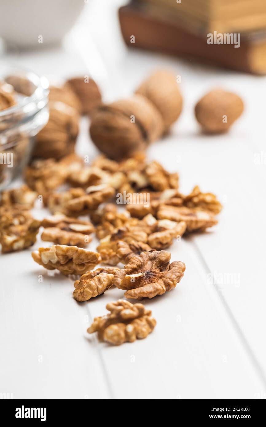 Peeled walnut kernels on white table. Stock Photo
