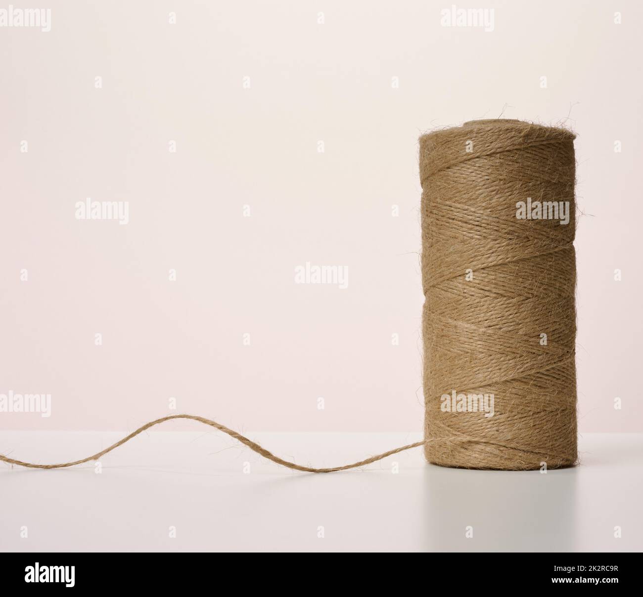 skein with a brown rope, roll with holiday wrapping paper