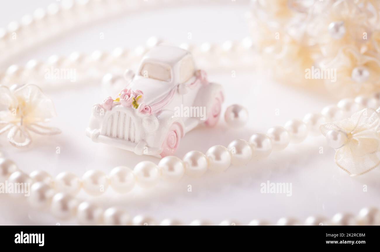Wedding still life with golden rings and pearl necklace in white Stock Photo