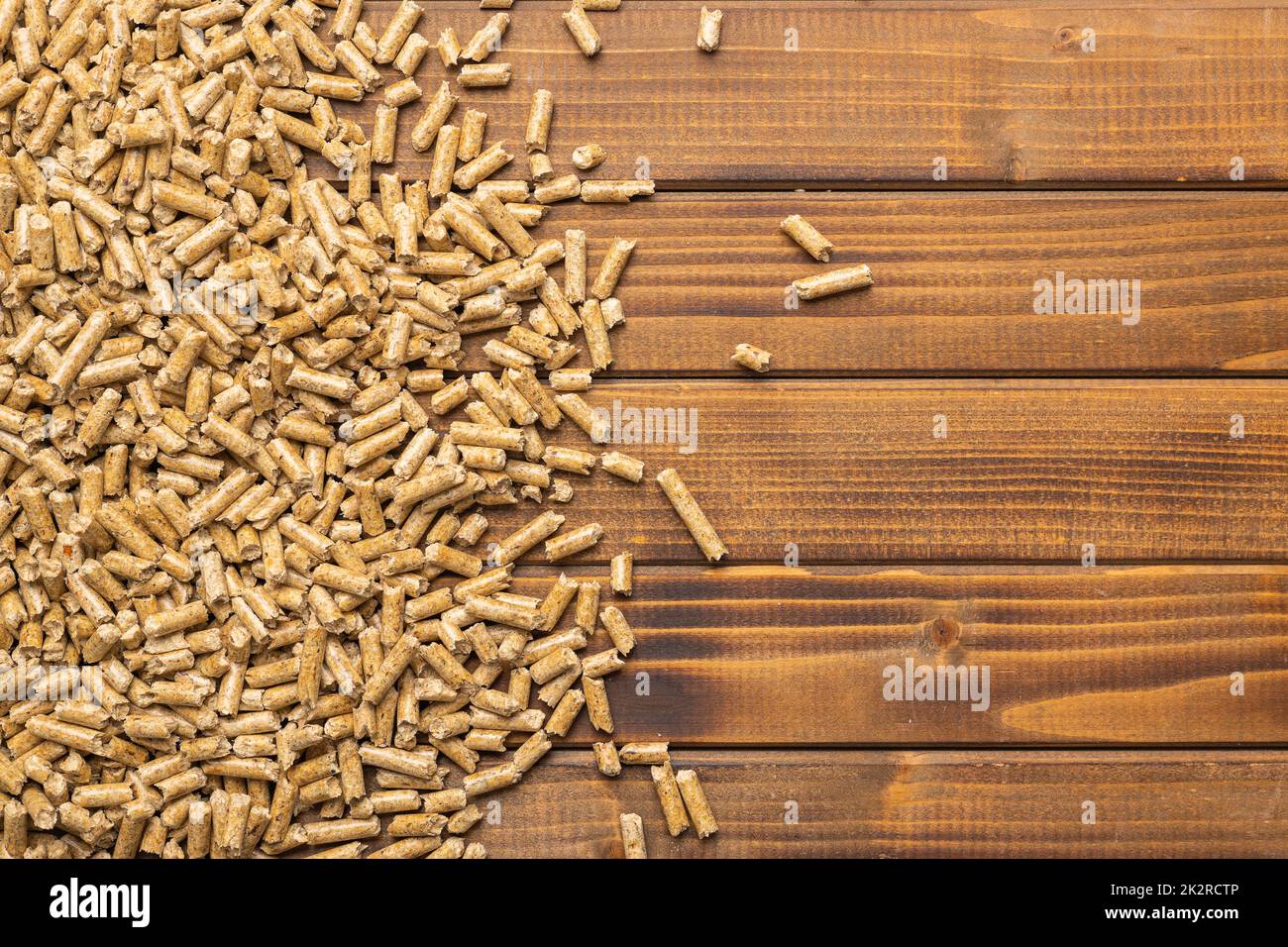 Wooden pellets, biofuel on wooden table. Ecologic fuel made from