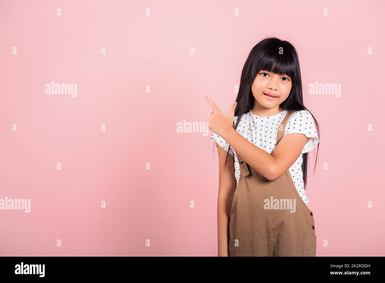 Asian little kid 10 years old point with index finger up Stock Photo