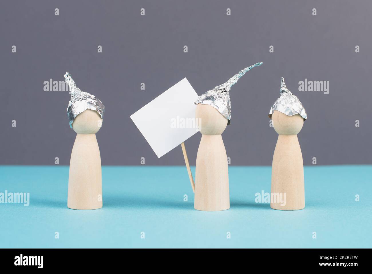 Group with alu hats protesters talking together, conspiracy theories, tin foil on the head, holding an empty sign, conversation and communication concept Stock Photo