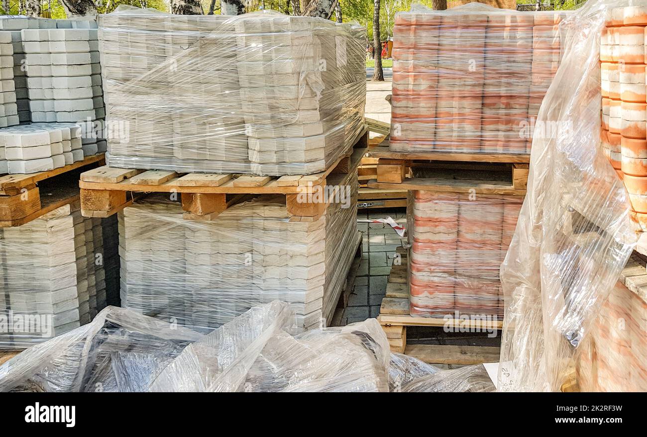 Close-up, the new paving slabs are neatly stacked on pallets. Repair of sidewalks and replacement of paving slabs. Reconstruction of urban infrastructure Stock Photo