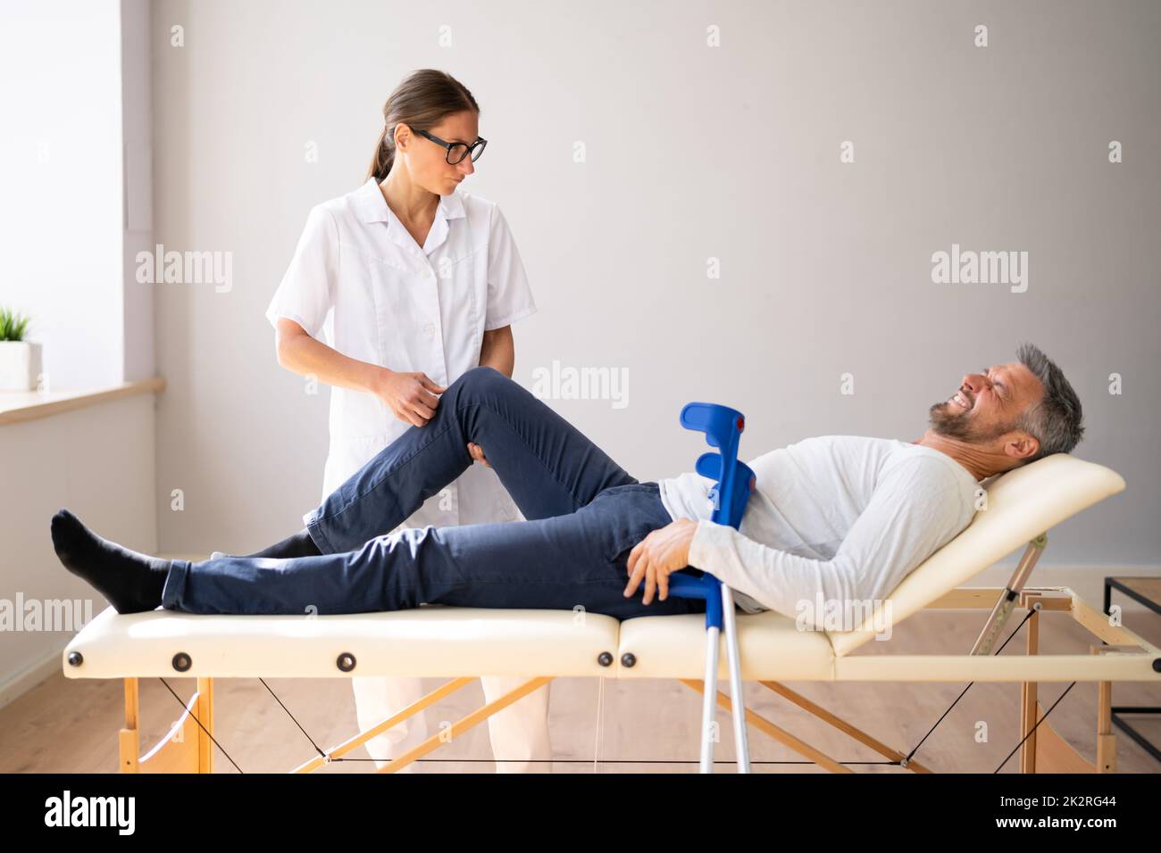 Physiotherapist Checking Man Patient Knee Stock Photo - Alamy