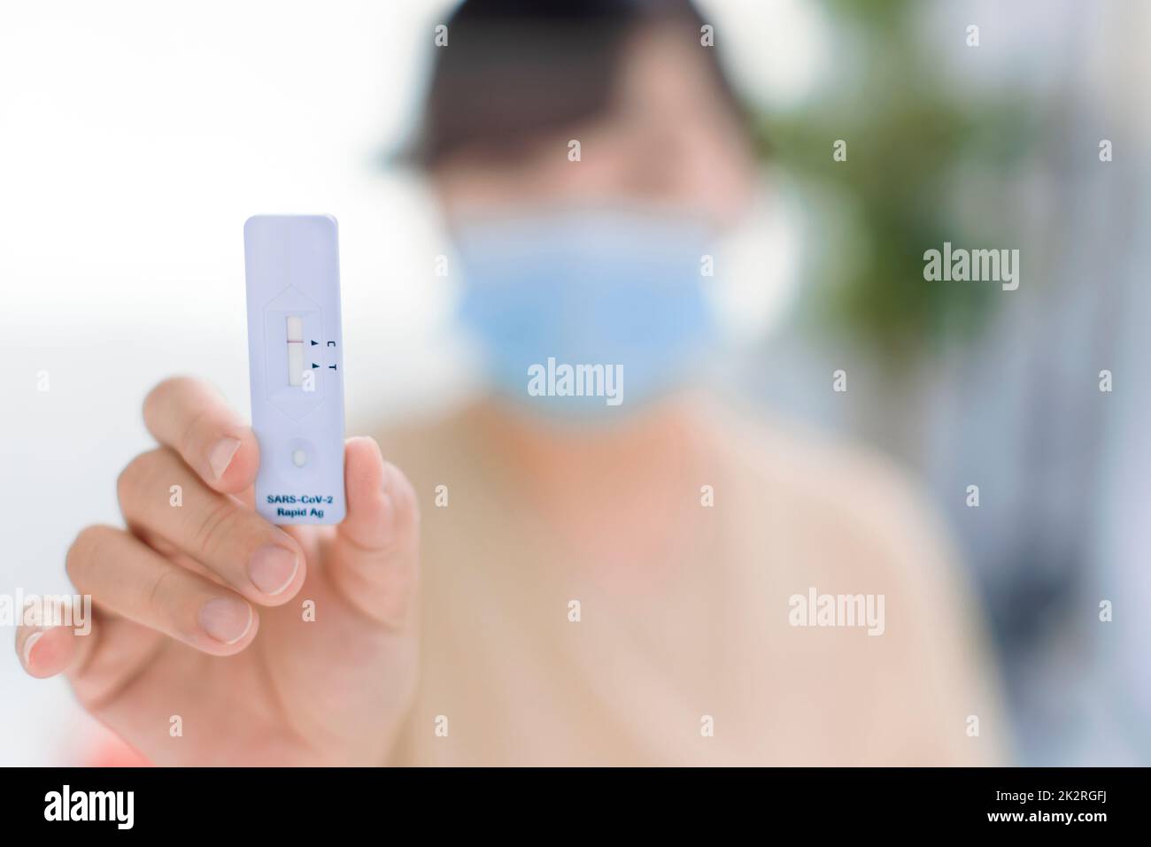 Woman showing antigen self test card with negative result for  Covid-19 Stock Photo